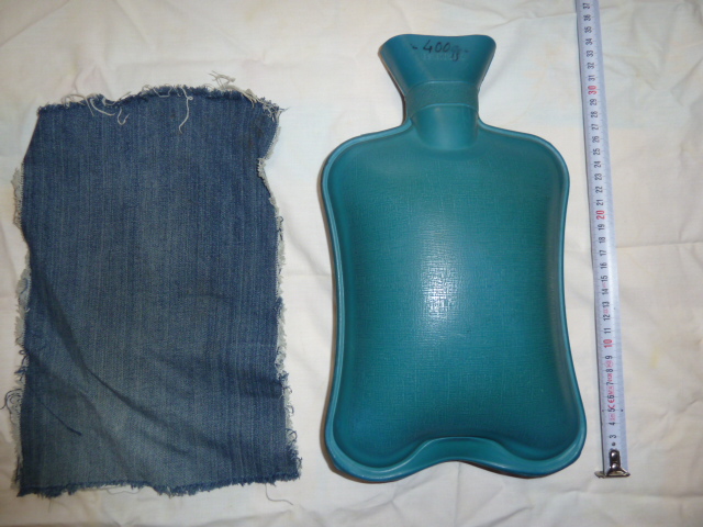 Photo of a blue rubber hot water bottle, view of the side with flat surface. Hot water bottle is used in Gardelle treatment method or to improve the work of the leaver.