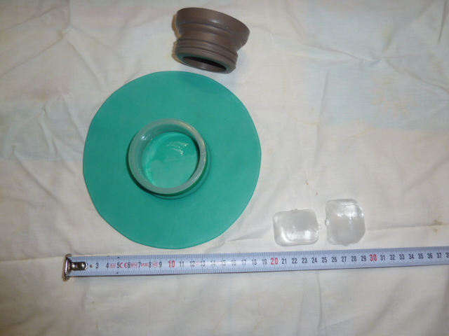 Photo of a blue green ice bag of 20 centimeters diameter, about 7.85 inches. Ice bag is used in Gardelle treatment method or to treat headaches as well.